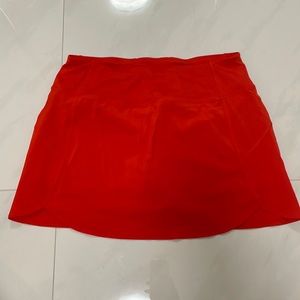 Positive orange tennis skirt